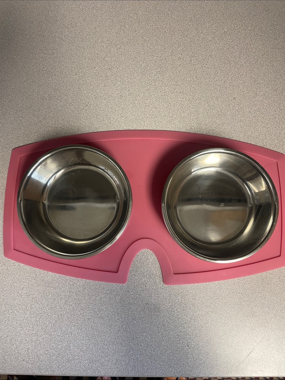 Small pet bowls in pink rubber mat